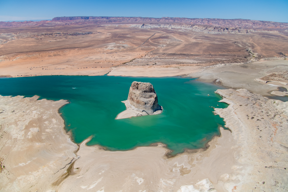 Lake Powell’s water level has dropped to its lowest level since it was filled in the 1960s, due in large part to a 20-year drought throughout the Colorado River Basin. As of November 2021, the reservoir was less than 30% full and continuing to drop. While these facts indicate a crisis of water availability for the American Southwest, the receding waters are also revealing side canyons that were drowned 50 years ago. The damming of Glen Canyon was considered by many environmentalists to be one of the most egregious acts of environmental destruction in the history of the American West, so the return of parts of the canyon is a welcome event for many.