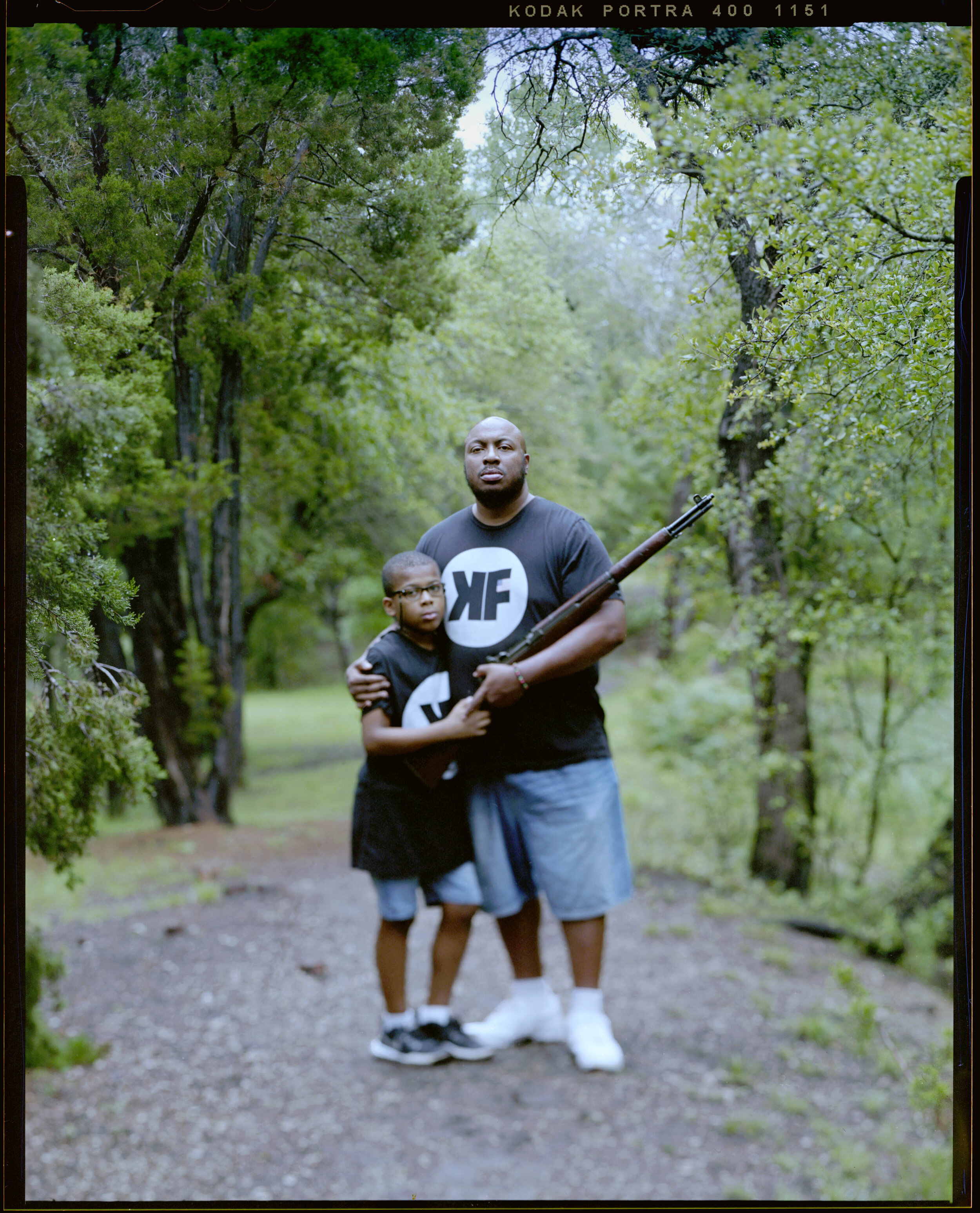 Aaron Banks, 38, and his son Aaron Banks Jr., 08, embrace at a local park  on Saturday, May 22, 2021 in Cedar Park, Tx.  “The image of the average gun enthusiast needs an update,” Mr Banks said. He is the President of Keep Firing LLC where he has made his son the CEO.  Currently he is one of 24 Pistol Instructors certified by the National African American Gun Association.