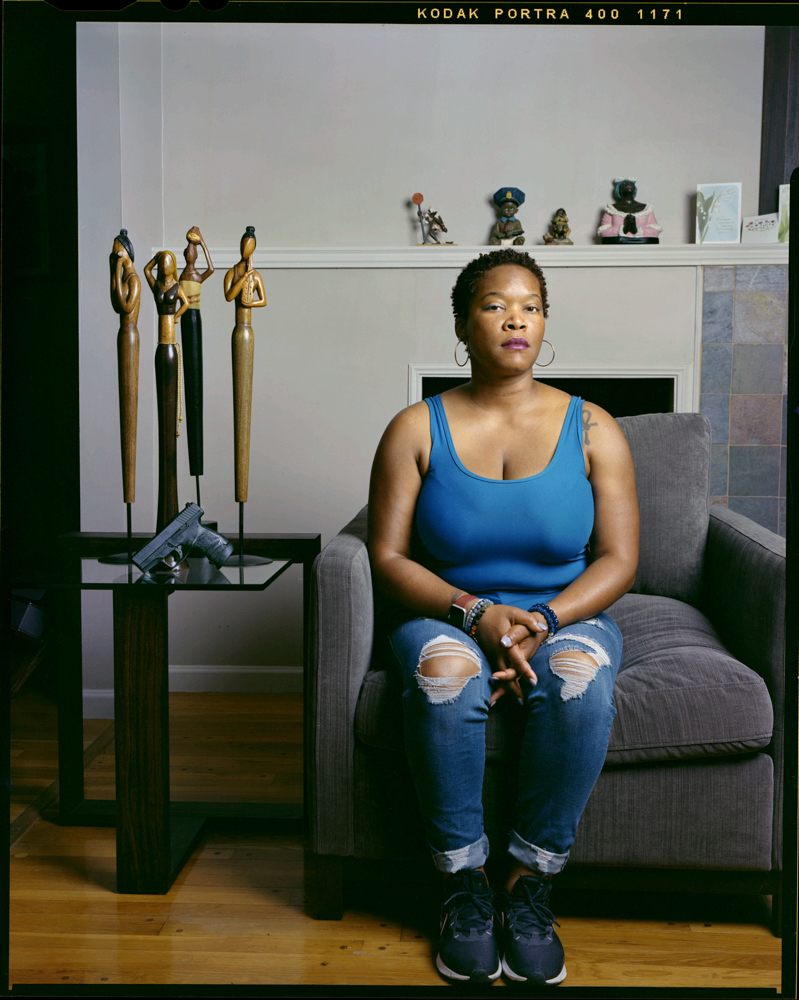 Tiana Tucker, 41, inside of her mother’s home on Tuesday, June 28, 2022 in Chicago. Tucker is a conceal carry firearm instructor. “With the new wave of violence and crime its necessary to protect yourself,” Tucker said.