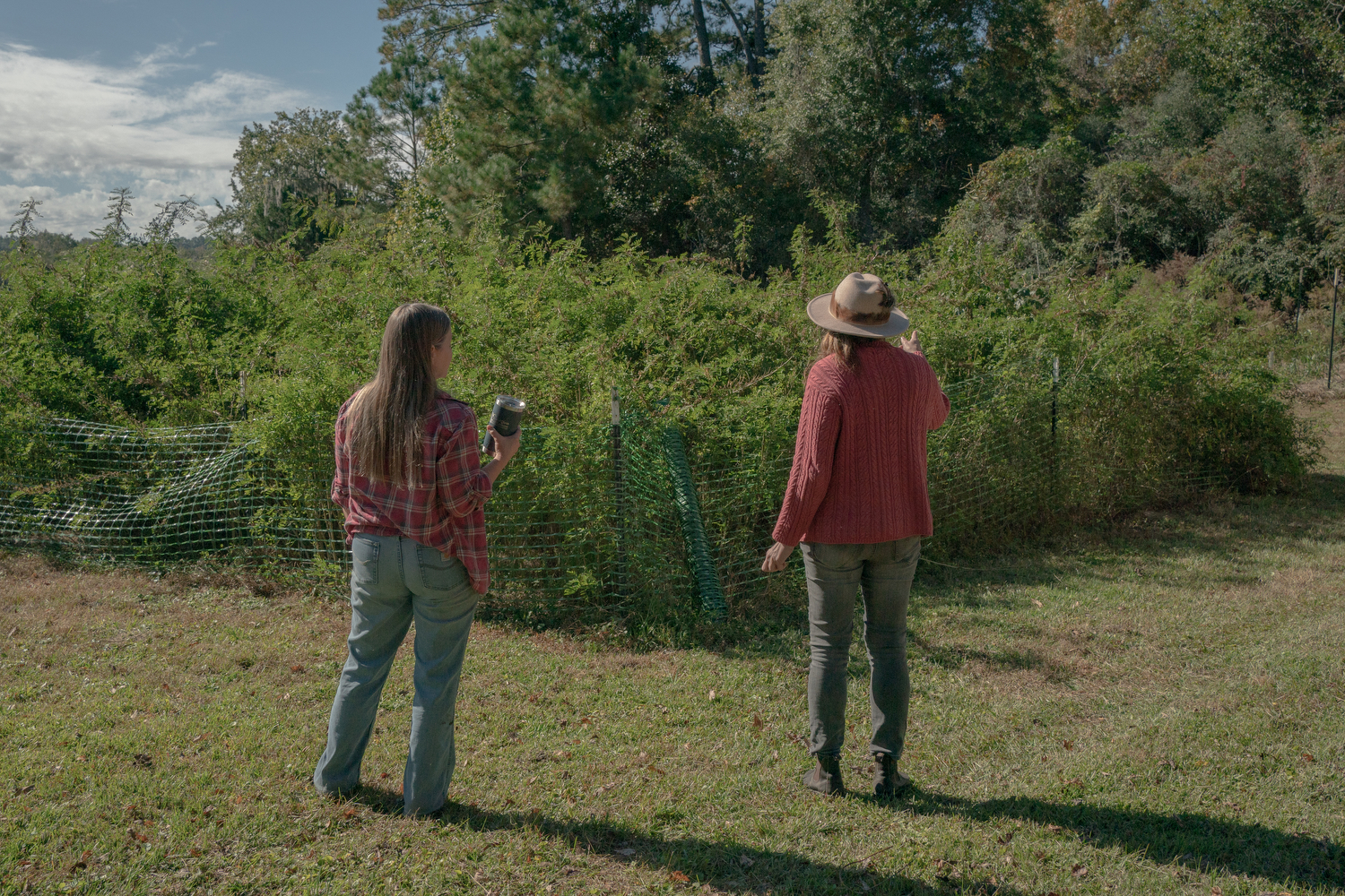 Kelly Fort, who runs Pluff Mudd Farm with her husband Dale, shows Ellie Maas Davis their field of indigo, in Wadmalaw Island, South Carolina.