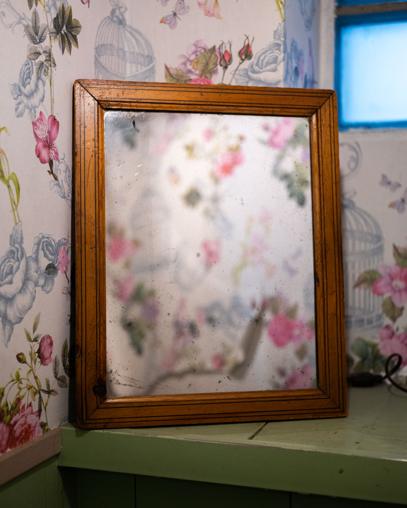 Mildew grows on the mirror in the restroom of a dive bar