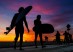 Surfers leave Venice beach at the end of the day on Friday.