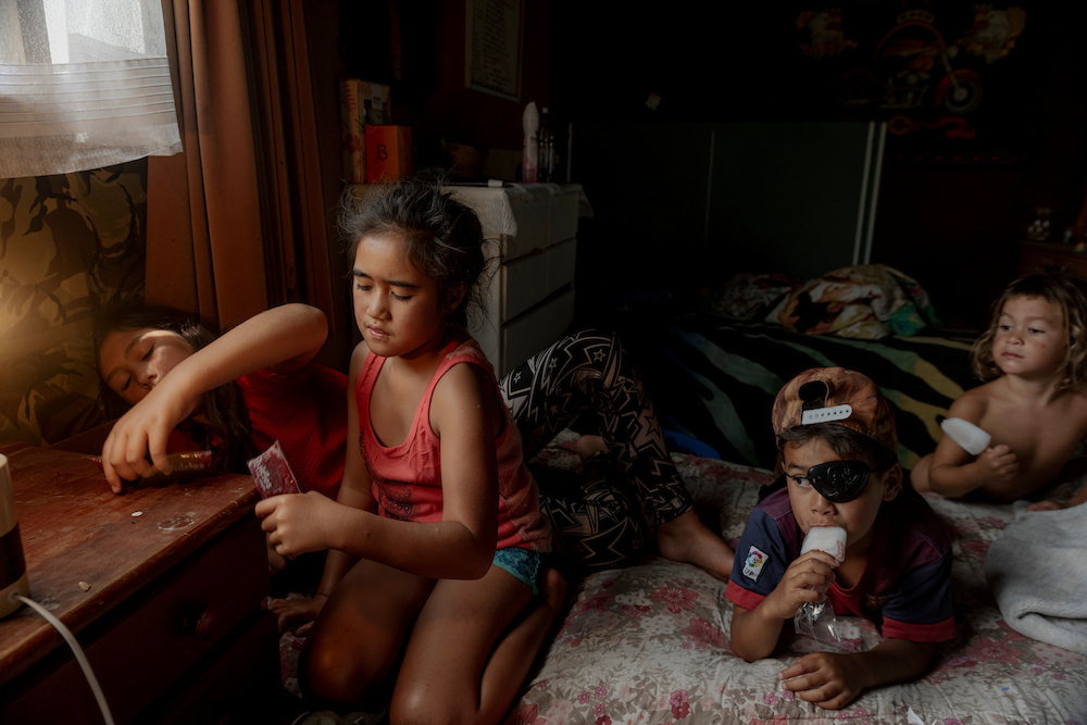 Children of the Teepa family enjoy ices on a hot summer’s day at their family farm, in Ruatoki, New Zealand. The annual summer holiday reunites city-dwelling cousins with their rural Tūhoe community, strengthening family bonds. In the past, many Tūhoe families sought employment elsewhere, leaving the land desolate for decades. Some, like John Teepa and his family, have returned to revive their ancestral homeland.
