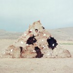Female farmer covered in sheepskins.