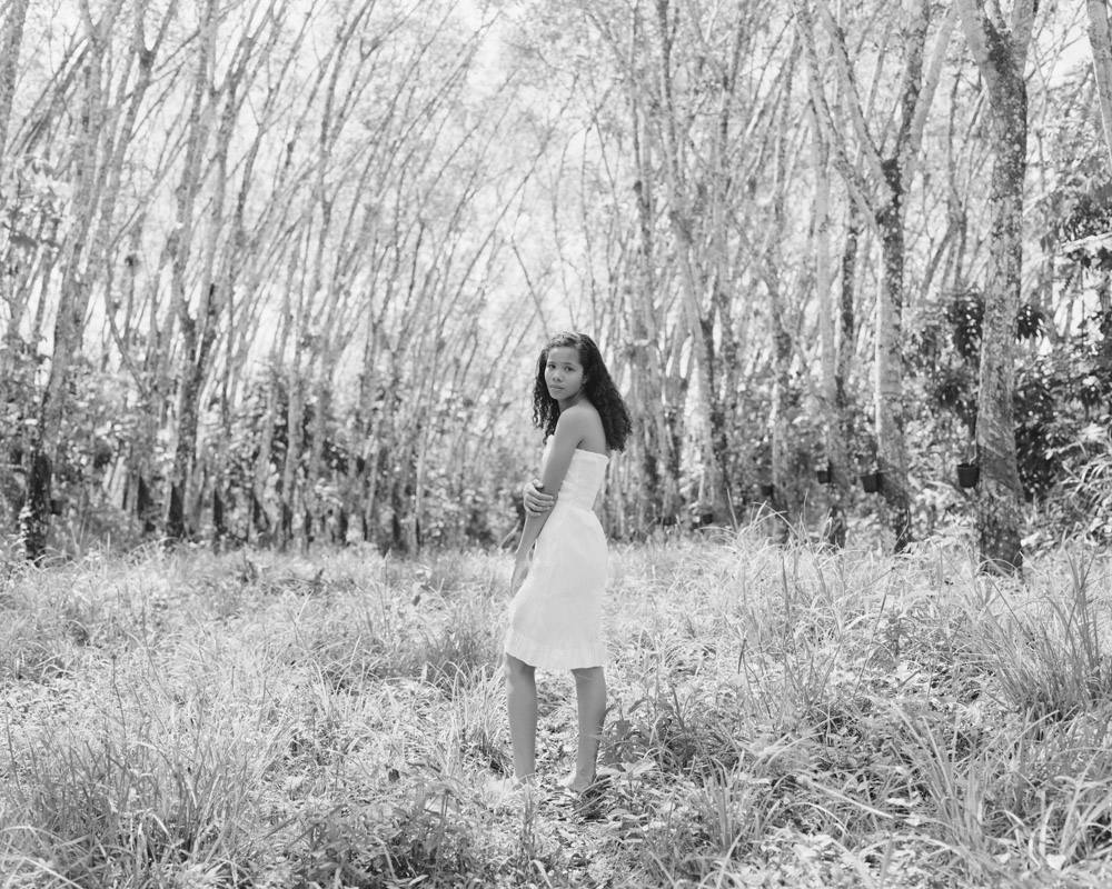 Emilly Farias in the Michelin Rubber Groves, Michelin Rubber Plantation, Bahia, Brazil. Archival pigment print, 42 × 52 ½ in. © Karolina Karlic. Overshoot with Yogan Muller.