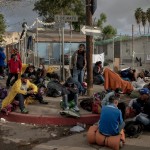 A group of migrants wait before being transferred to a different temporary shelter in Tijuana, Mexico on November 30, 2018. Mexican officials required all the migrants to leave the Benito Juarez encampment due to safety and hygienic concerns and move instead to the outskirts of Tijuana to the El Barretal complex.

Photo by Kitra Cahana / MAPS