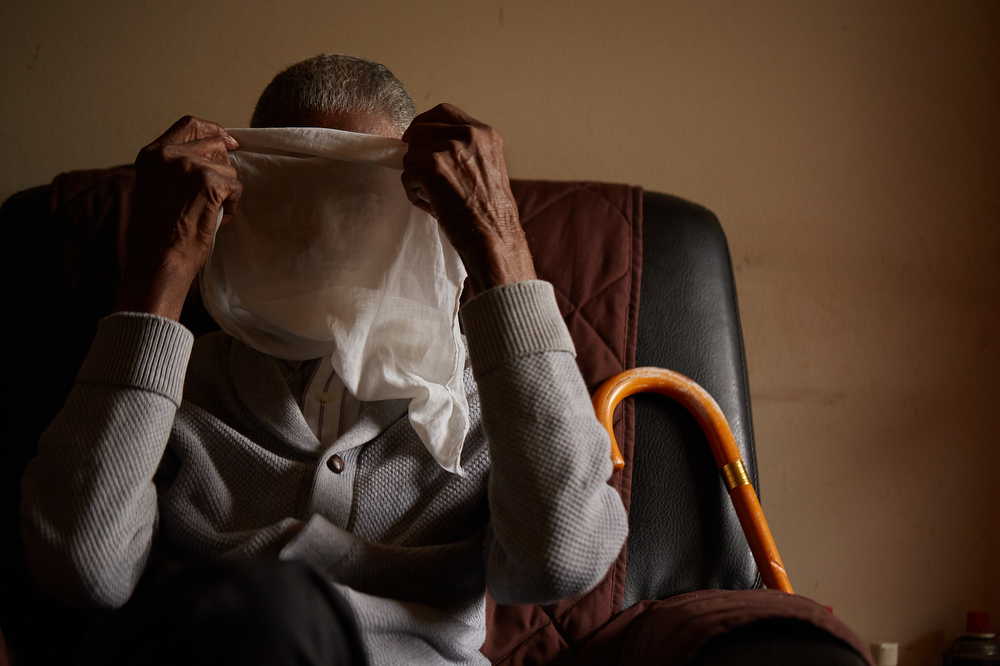 Deacon B.C. Mance, 103, at his home in Toccoa, Georgia. I made this photo early in the project. It was serendipity, the way I captured the veil over his face in the split second he flung it upward, but it has become an important symbol that reappears in the work. Hidden faces, whether obscured or looking away, represent how Affrilachians have been overlooked in Appalachian, as well as American, narratives. March 4, 2017.