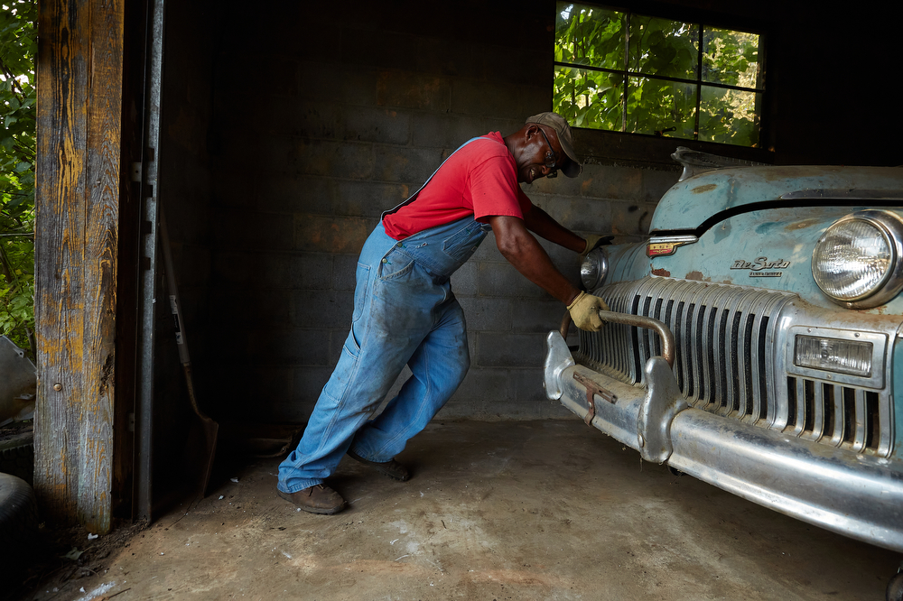 Six months after his father’s death, Timmy Joe Jenkins moves an old DeSoto Coupe that hasn’t run for years while cleaning out his father’s mechanic shop in the Oak Springs community of Cleveland, GA, August 28, 2018.
