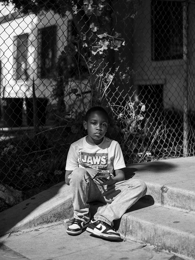 1 © Christian Lee, Boy Near Fence, Crenshaw, 2025